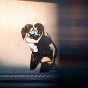 wall art-couple in masks-kissing