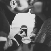 couple-kissing-over coffee